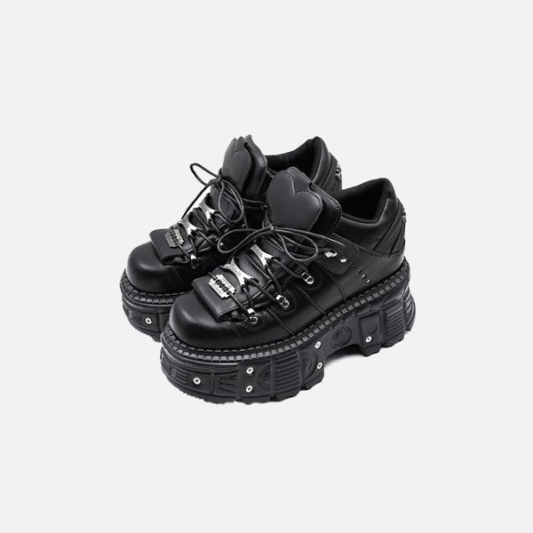 Front view of the black Heart-Tongue Platform Sneakers in a gray background