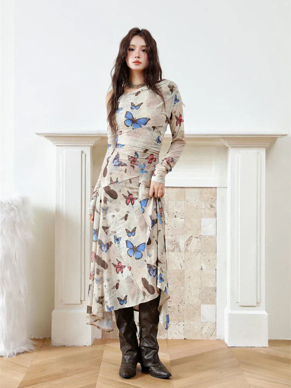 Woman wearing a long dress with butterfly pattern in a room with a fireplace.