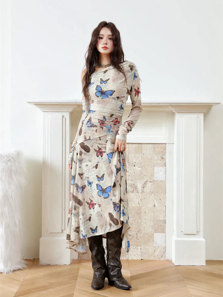 Woman wearing a long dress with butterfly pattern in a room with a fireplace.